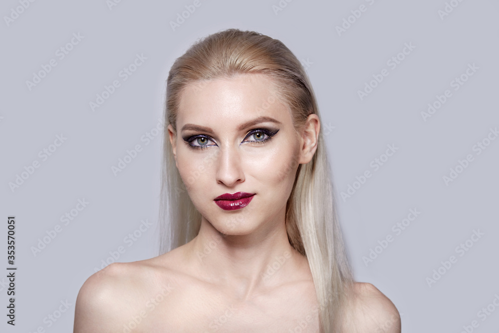 Bright make-up in a woman with bare shoulders. Stylish haircut. Bright make-up in a woman with bare shoulders. Stylish haircut.