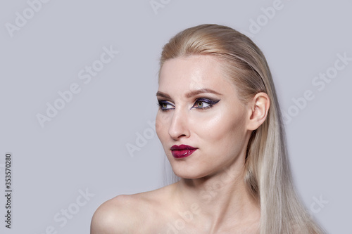 Fashionable, stylish set in the studio with a blonde girl with bright makeup