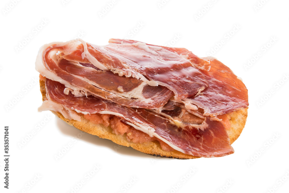 Mollete with jamón ibérico and tomato, typical spanish food, isolated on white background. Mollete with jamón ibérico and tomato, typical spanish food, isolated on white background.