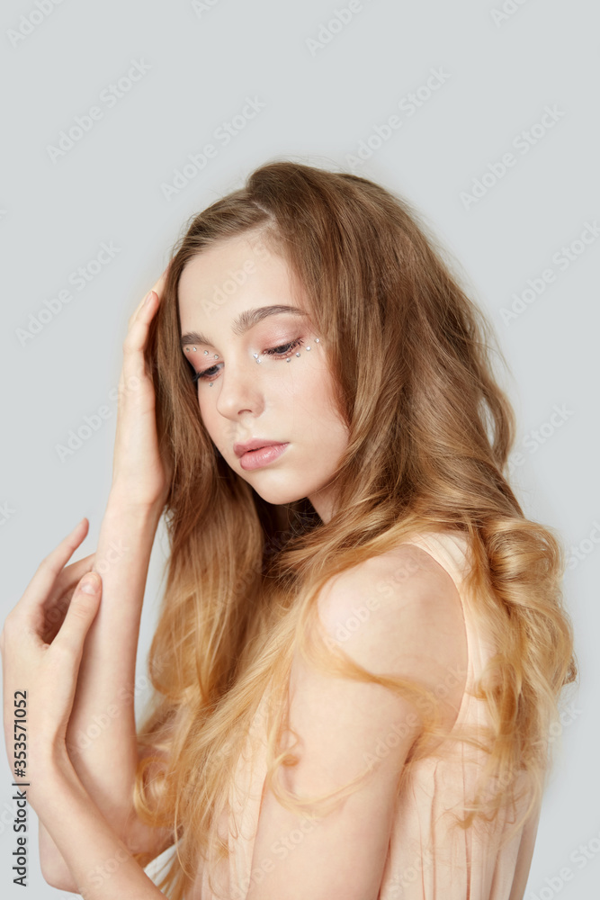 Vertical photo of a young blonde girl with curly hair. Vertical photo of a young blonde girl with curly hair.