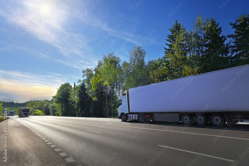 White truck transport on the road at sunset and cargo White truck transport on the road at sunset and cargo