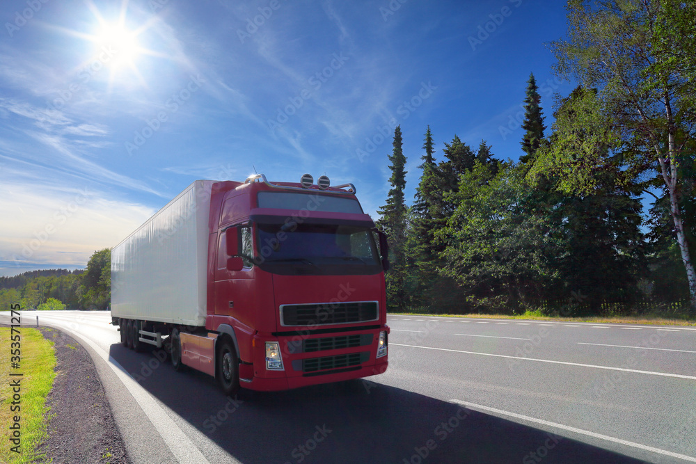 Red truck transport on the road at sunset and cargo Red truck transport on the road at sunset and cargo