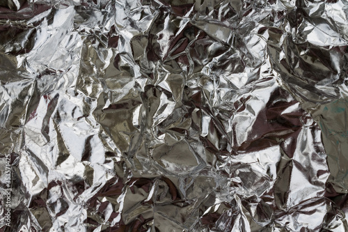 Abstract background with metallic broken reflection effect. black and white monochrome silver foil backdrop for your design. Macro shooting