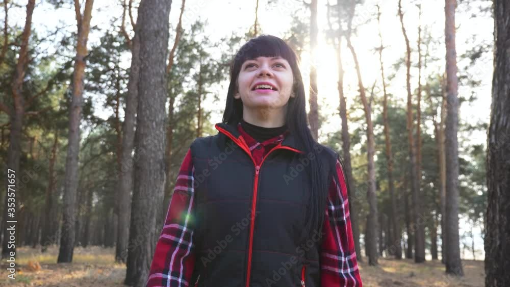 Young brunette woman on a walk. A girl walks in the Park, enjoys the fresh air, beautiful nature. Young brunette woman on a walk. A girl walks in the Park, enjoys the fresh air, beautiful nature.