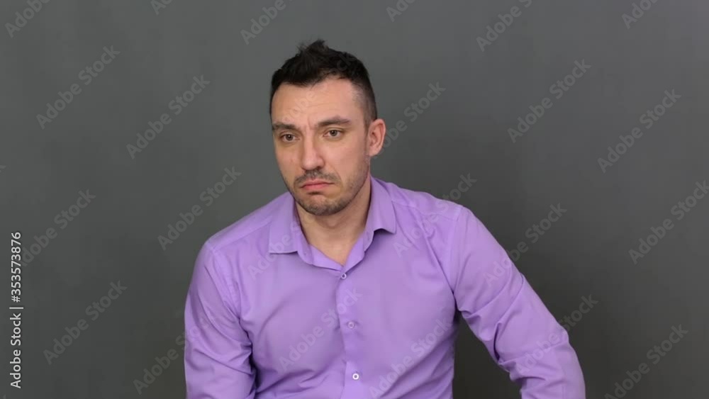 Closeup young man shows regret. He shows emotions professionally. Soft light. High-quality footage FullHD. Closeup young man shows regret. He shows emotions professionally. Soft light. High-quality footage FullHD.