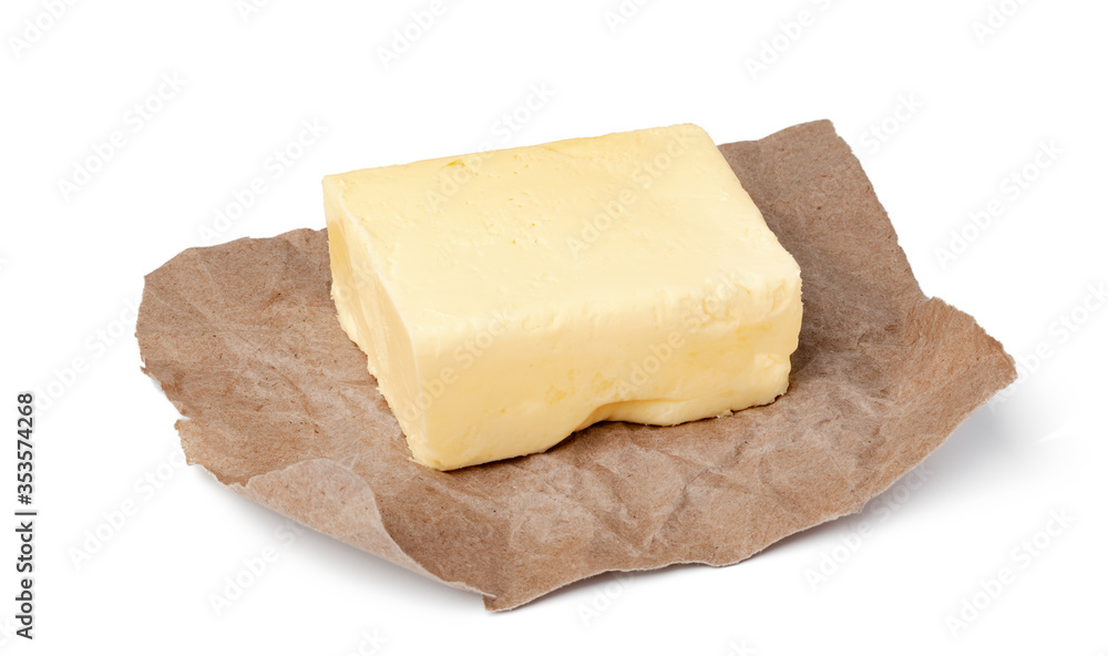 Fresh butter on craft paper isolated on white background