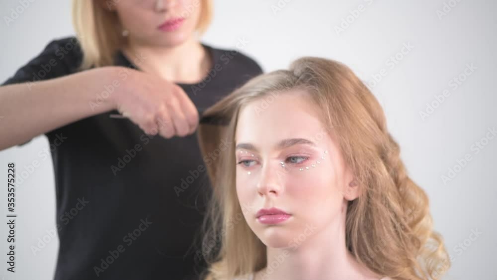 Creating hairstyles in a young girl with blond hair. Creating hairstyles in a young girl with blond hair.