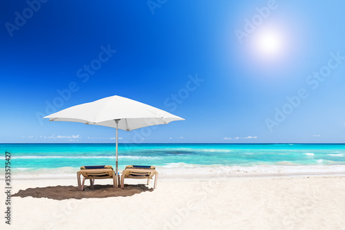 Beach chairs with umbrella and beautiful sand beach in Punta Cana  Dominican Republic