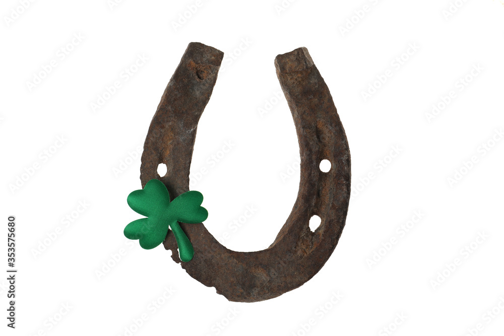 Old horseshoe and clover on white background. St. Patrick's Day celebration Old horseshoe and clover on white background. St. Patrick's Day celebration