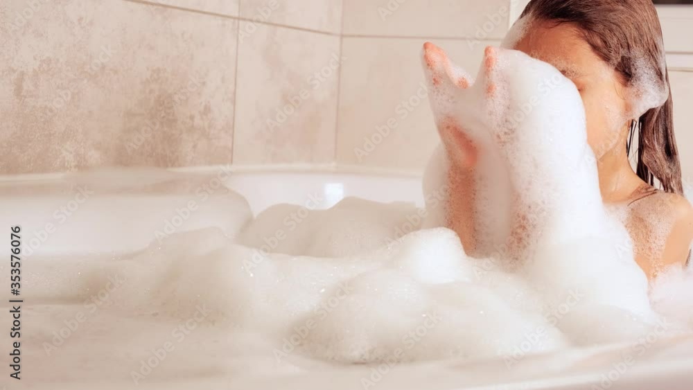 Little girl bathes in bathtub and plays with foam, Hygiene and Baby Care Concept, 4K UHD still video camera, 2x slow motion. Little girl bathes in bathtub and plays with foam, Hygiene and Baby Care Concept, 4K UHD still video camera, 2x slow motion.