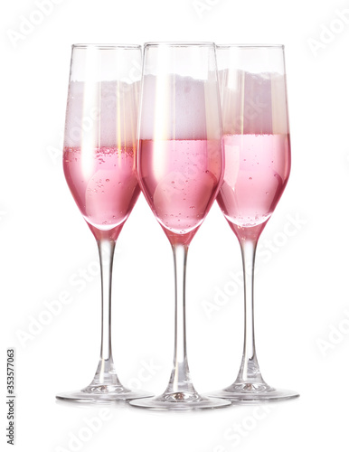 Glasses of tasty champagne on white background