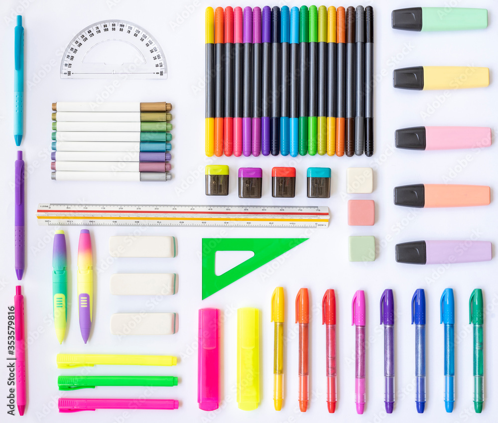 Obraz premium School and office supplies of various colors: rulers, erasers, markers, pens, pencil sharpeners on a white background. Top view. Background
