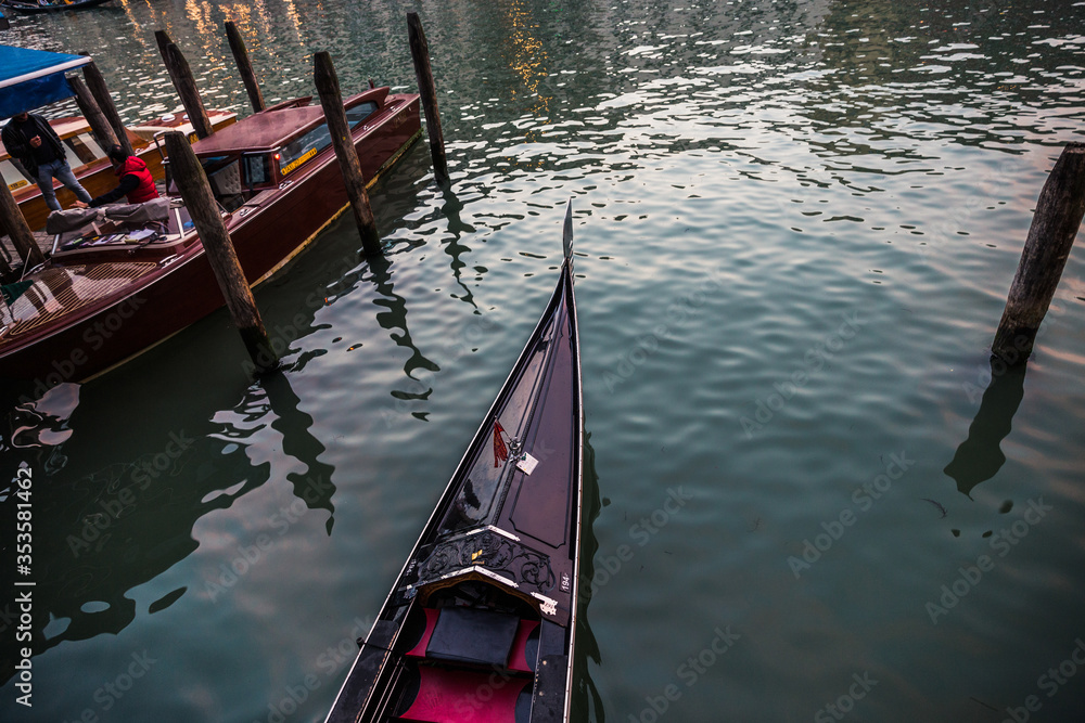 The shiny nose trim of a traditional Venetian gondola (aka Ferro) on calm water, Venice, Italy