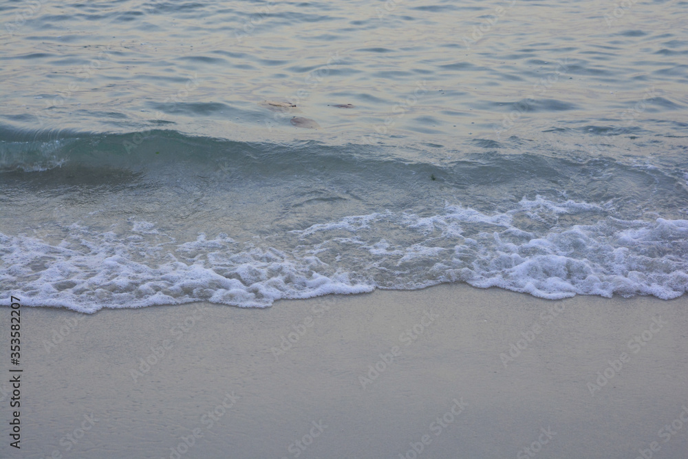 Wave of sea water and sand in evening