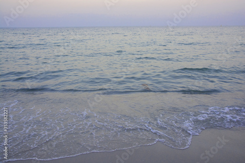 Wave of sea water and sand in evening