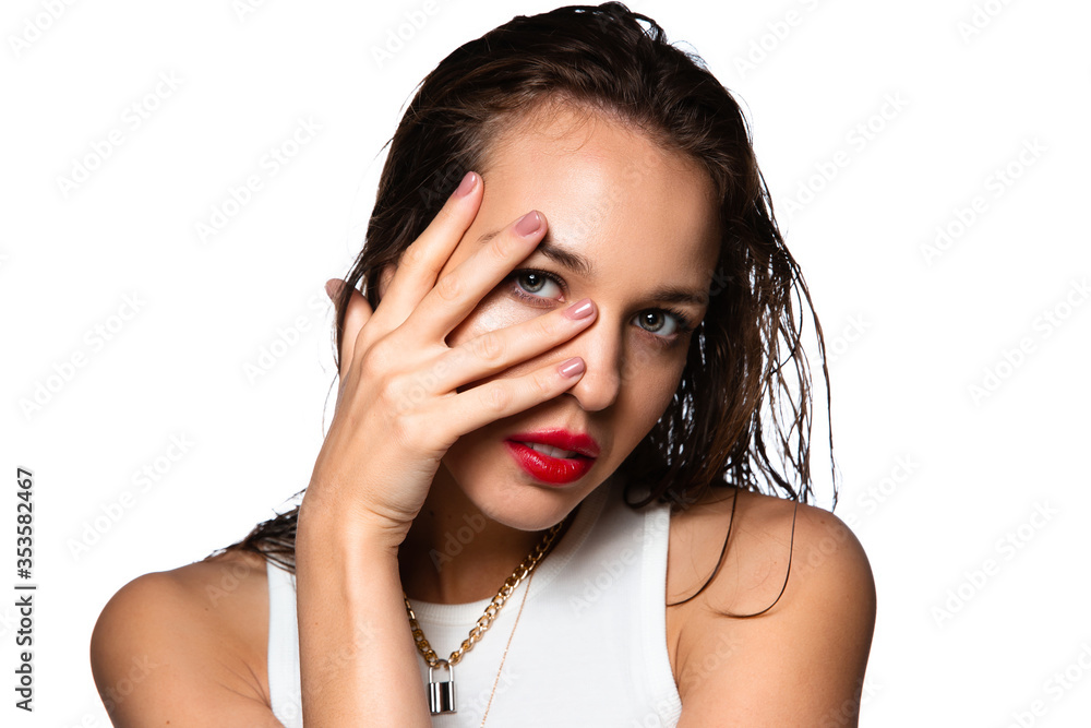 Fototapeta premium Sensual look. Portrait of beautiful stylish woman isolated on white studio background. Caucasian brunette model with bright red lipstick, wet hair and shiny skin. Beauty, fashion, emotions concept.