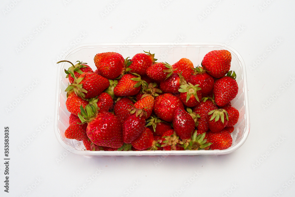 Tray of ripe red strawberries on a white background. Tray of ripe red strawberries on a white background.