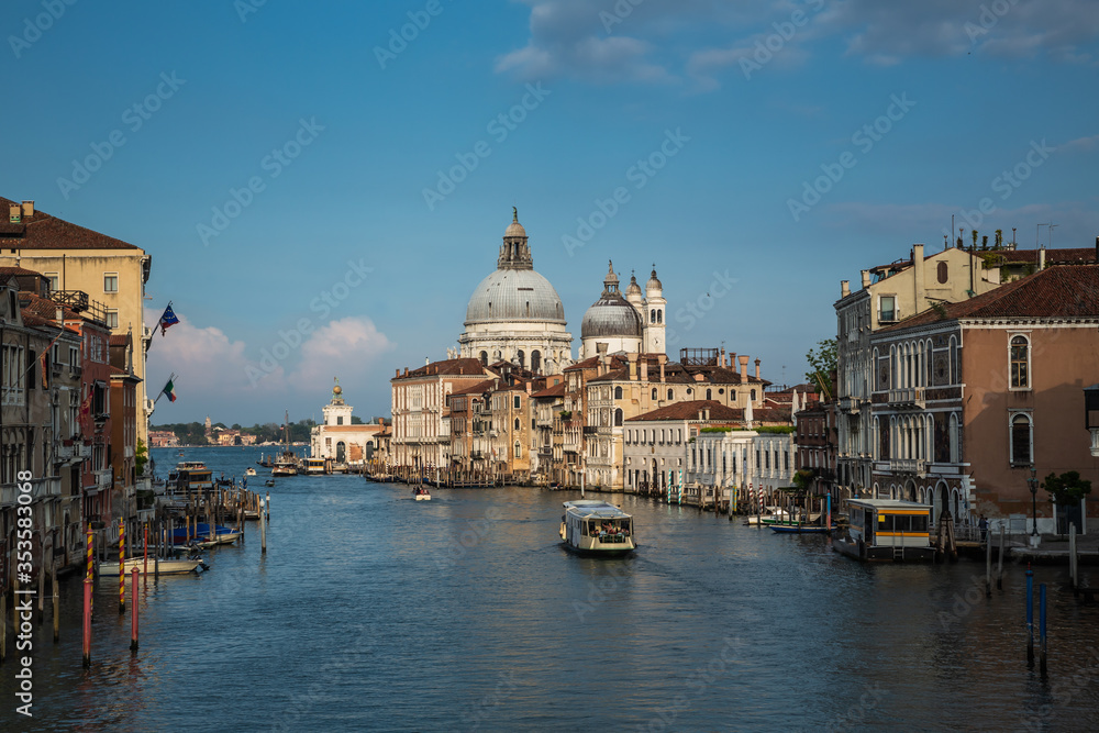 Beautiful view of famous Canal Grande and Basilica di Santa Maria della Salute in daylight, Venice, Italy