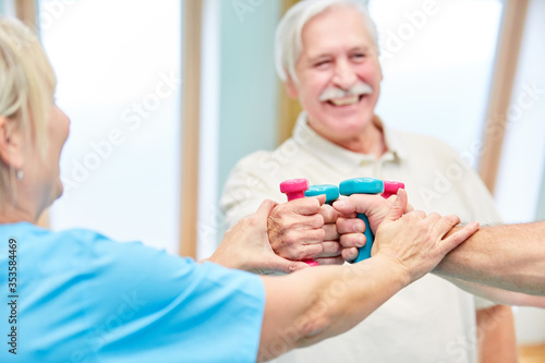 Seniors do dumbbell training in rehabilitation sports