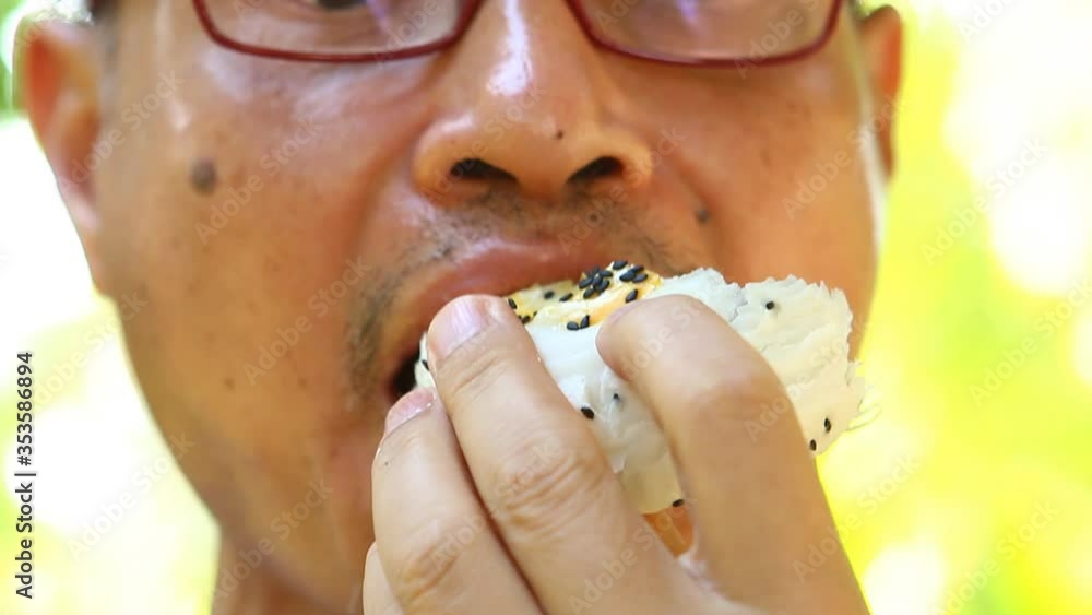 Man eating chinese pastry , outdoor Chiangmai Thailand Man eating chinese pastry , outdoor Chiangmai Thailand