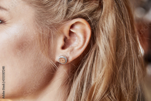 Woman ear wearing beautiful luxury earring