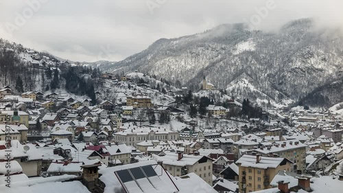 Idrija, Slovenia - December 19, 2014: Idrija is a town in western Slovenia. It is notable for its mercury mine, for lace-making and for culinary specialty zlikrofi. Time lapse on a winter snowy day. photo