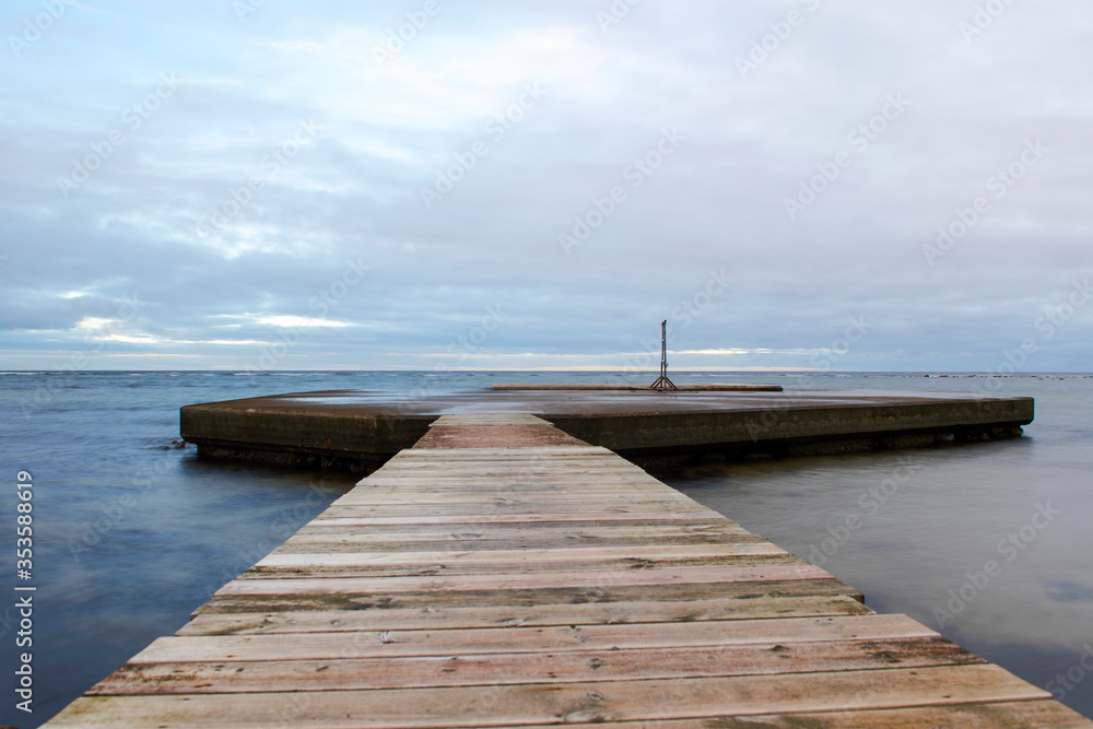 Bathing pier with ocean and cloudy sky background at island of Gotland, Sweden