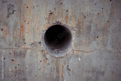 stained reinforced concrete texture with a hole