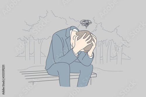 Despair, frustration, depression, business concept. Desperate young businessman crying in his hands sitting on bench covering head. Fatigue headache or migraine bad news and raising of mental stress.