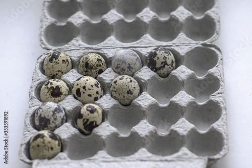 Quail eggs on the white kitchen table. Concept of preparation for baking. The view from the top.