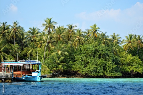 amazing view of fishing boat and landscape of tropical island of Maldives photo