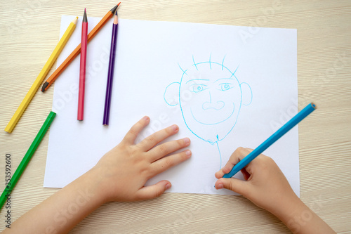 little girl drawing with pencils