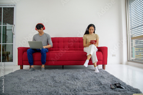 New normal Man women stay home on sofa social distancing