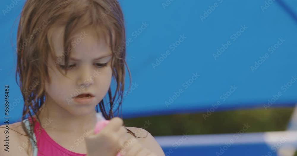 Little girl playing in the swimming pool Little girl playing in the swimming pool