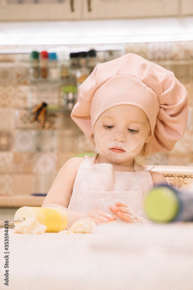 Little girl cooks at home in the kitchen Little girl cooks at home in the kitchen