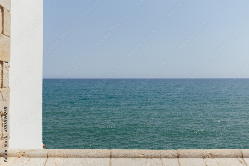 Selective focus of seascape with blue sky at background in Catalonia, Spain