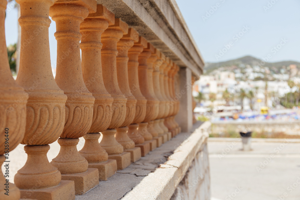Fototapeta premium Selective focus of wall with baluster and sunlight on urban street in Catalonia, Spain