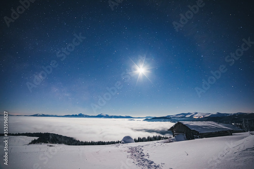 View at the starry sky over snowy hills. Location place Carpathian mountains, Ukraine, Europe. © Leonid Tit