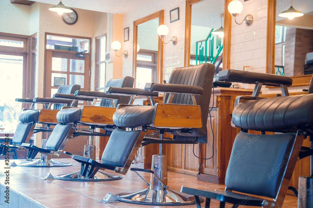 Empty chairs in retro styled barbershop. Hair salon interior.