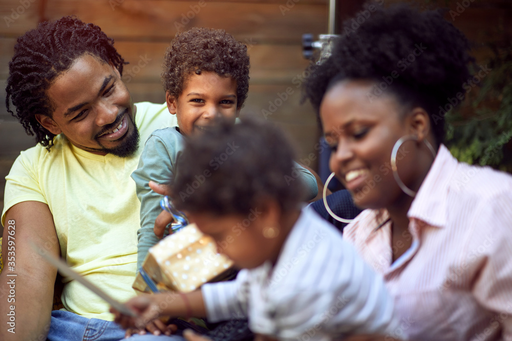 Happy Afro-American family enjoying together outdoor at birthday party. Happy Afro-American family enjoying together outdoor at birthday party.