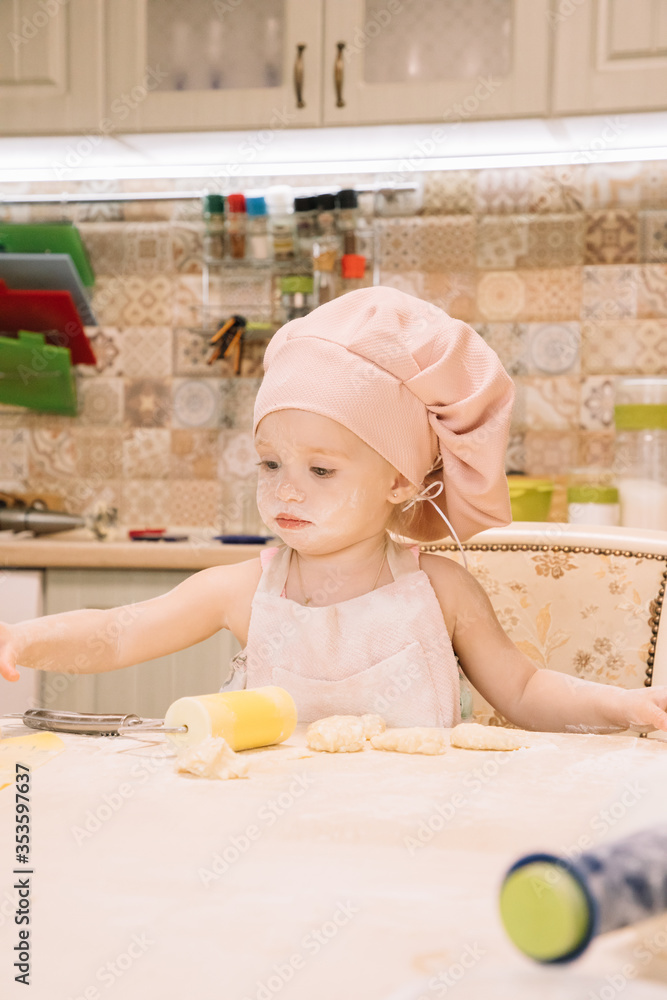 Little girl cooks at home in the kitchen Little girl cooks at home in the kitchen