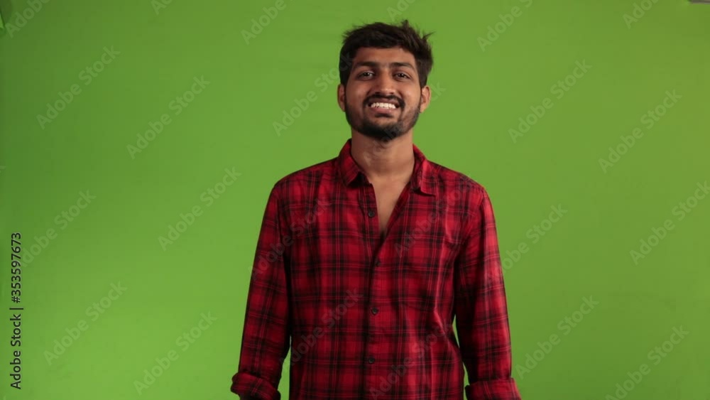Portrait of happy Indian guy on green screen. Smiling asian businessman looking at camera on Green Chroma Key background. Portrait of happy Indian guy on green screen. Smiling asian businessman looking at camera on Green Chroma Key background.