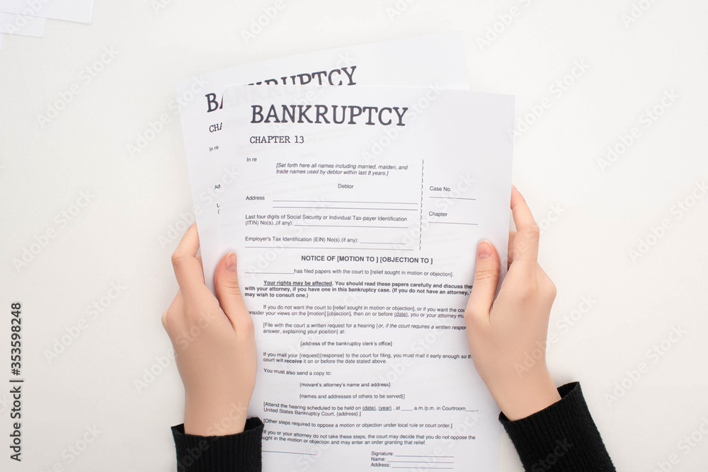 partial view of woman holding bankruptcy papers on white background partial view of woman holding bankruptcy papers on white background