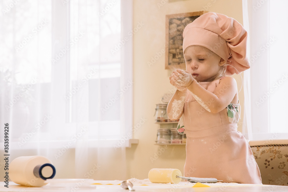 Little girl cooks at home in the kitchen Little girl cooks at home in the kitchen