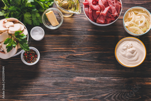 Ingredients for beef stroganoff with mushrooms on table