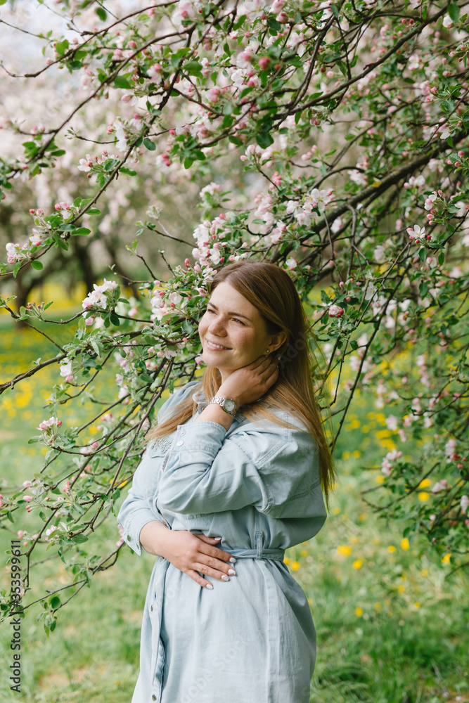 Girl in a flowering garden. A young blond woman is walking in a park. Portrait of a beautiful girl in the park. Girl in a flowering garden. A young blond woman is walking in a park. Portrait of a beautiful girl in the park.