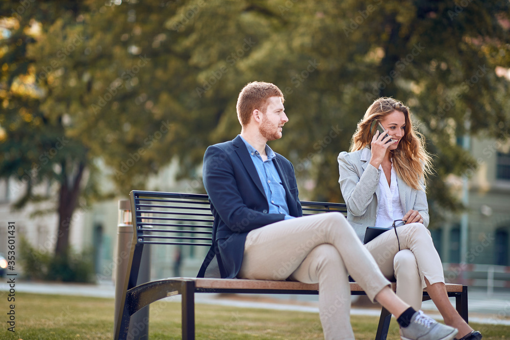 young business people sitting outdoor on bench on break young business people sitting outdoor on bench on break
