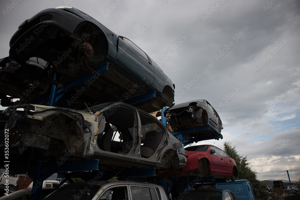 A car graveyard, with damaged vehicles, one on top of each other, which awaiting recycling or dismantling, Kozani, Greece. A car graveyard, with damaged vehicles, one on top of each other, which awaiting recycling or dismantling, Kozani, Greece.