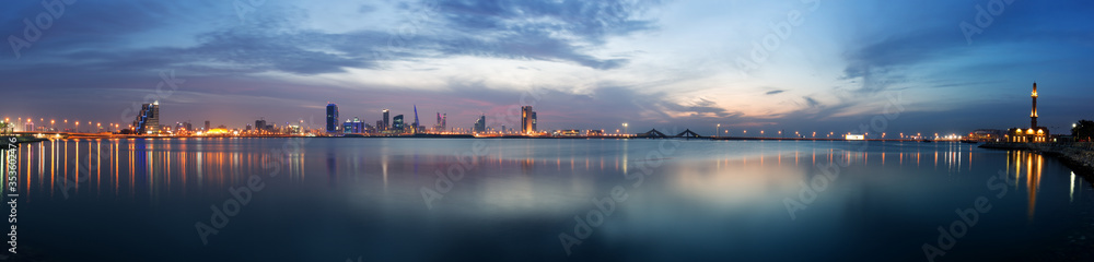 Panormic view of Bahrain skyline with reflection after sunset