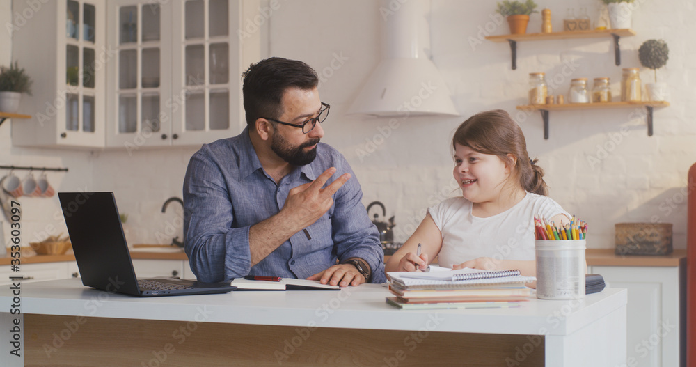 Fototapeta premium Daughter studying at home with his father